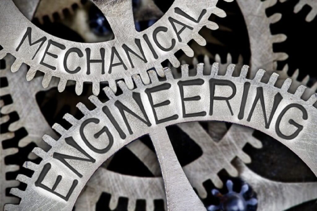 Macro photo of tooth wheel mechanism with MECHANICAL ENGINEERING letters imprinted on metal surface
